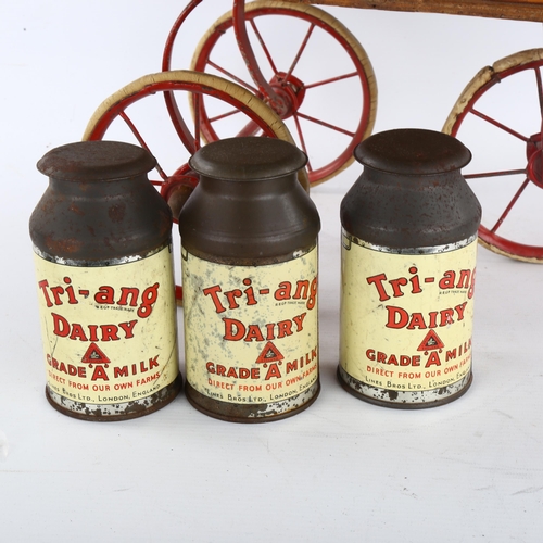 357 - A rare Tri-ang toy milk cart, stained wood and metal, containing original tinplate milk churns and p... 