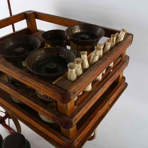 357 - A rare Tri-ang toy milk cart, stained wood and metal, containing original tinplate milk churns and p... 