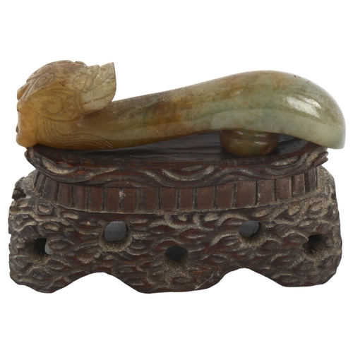 368 - A Chinese carved jade dragon design buckle on hardwood stand, length 8cm