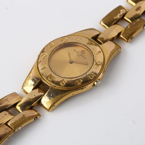 1056 - BAUME & MERCIER - a mid-size gold plated stainless steel quartz bracelet watch, champagne dial with ... 