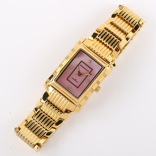 1059 - DIAMOND & CO - a lady's gold plated stainless steel quartz bracelet watch, ref. DC012, pink mother-o... 