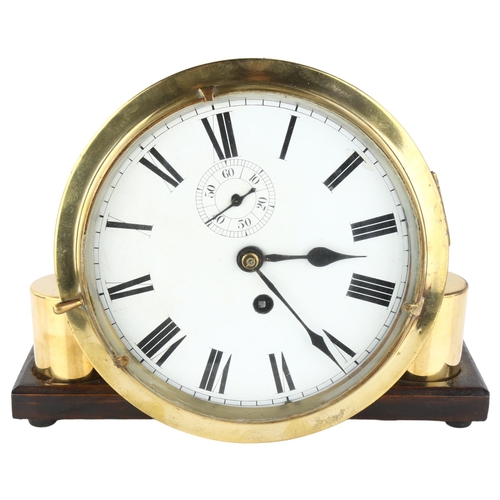 1074 - An Antique brass ship's bulkhead clock, white enamel dial with Roman numeral hour markers and subsid... 