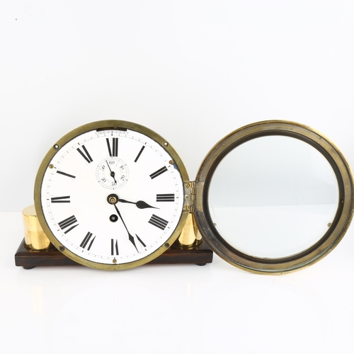 1074 - An Antique brass ship's bulkhead clock, white enamel dial with Roman numeral hour markers and subsid... 