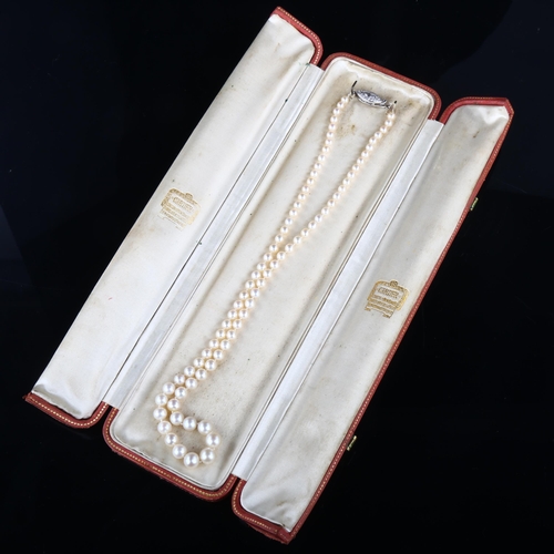 1100 - CARTIER - a natural saltwater pearl and diamond necklace, a graduated strand of 82 natural pearls of... 