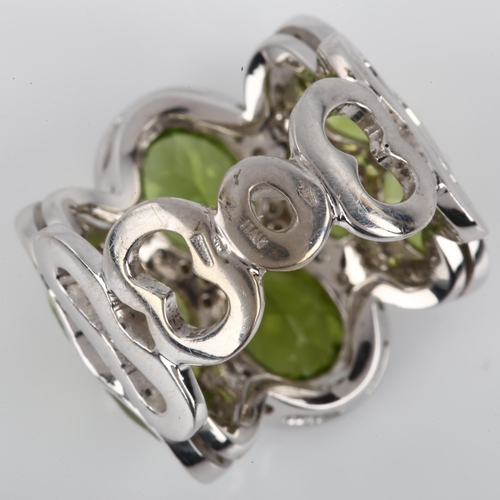 1123 - A large Italian 18ct white gold peridot and diamond cluster cocktail ring, set with oval mixed-cut p... 