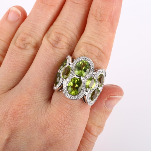 1123 - A large Italian 18ct white gold peridot and diamond cluster cocktail ring, set with oval mixed-cut p... 