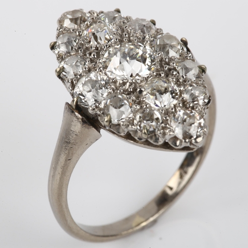 1125 - A diamond marquise cluster ring, unmarked white metal settings with old European-cut diamonds, total... 