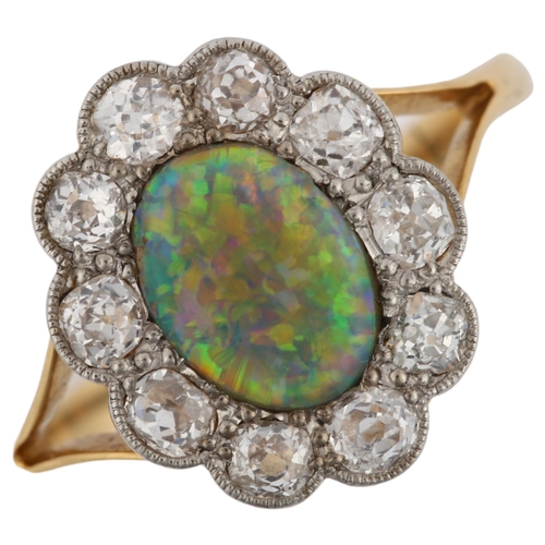 1130 - An 18ct gold black opal and diamond cluster ring, set with oval cabochon black opal and old European... 