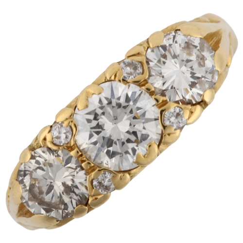 1131 - A late 20th century 18ct gold graduated three stone diamond half hoop ring, set with modern round br... 