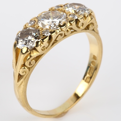 1131 - A late 20th century 18ct gold graduated three stone diamond half hoop ring, set with modern round br... 