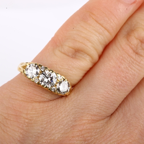 1131 - A late 20th century 18ct gold graduated three stone diamond half hoop ring, set with modern round br... 