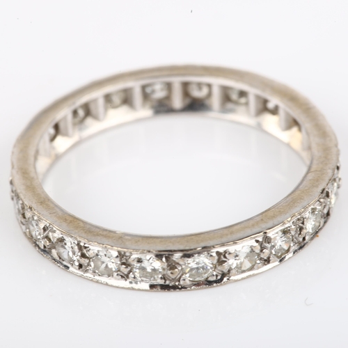 1132 - A full eternity diamond ring, unmarked white metal settings with modern round brilliant-cut diamonds... 