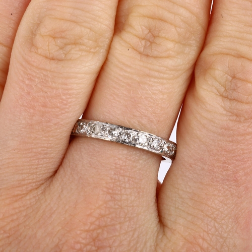 1132 - A full eternity diamond ring, unmarked white metal settings with modern round brilliant-cut diamonds... 