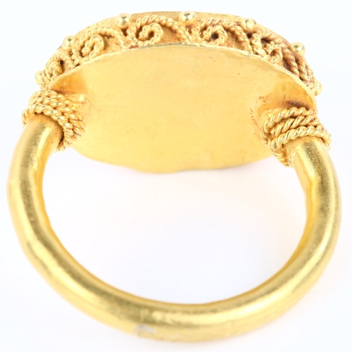 1137 - A Victorian style seal ring, unmarked yellow metal settings with wirework surround and intaglio carv... 