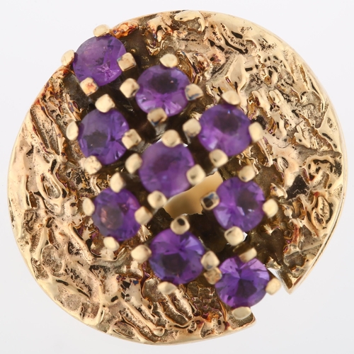 1160 - A 1970s 9ct gold amethyst abstract ring, set with round-cut amethysts and folded textured shoulders,... 