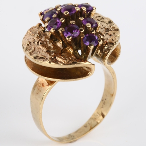 1160 - A 1970s 9ct gold amethyst abstract ring, set with round-cut amethysts and folded textured shoulders,... 