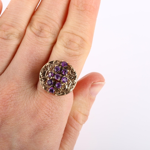 1160 - A 1970s 9ct gold amethyst abstract ring, set with round-cut amethysts and folded textured shoulders,... 