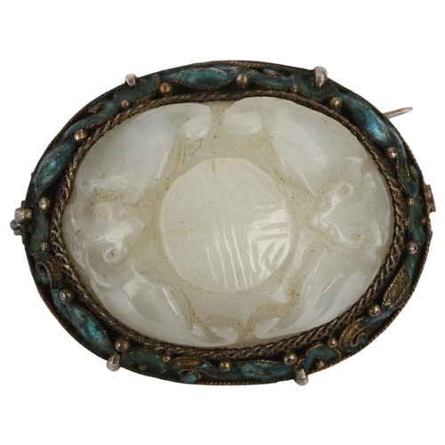 1168 - A Chinese jade and enamel Good Fortune brooch, relief carved with bats and seal, in unmarked white m... 