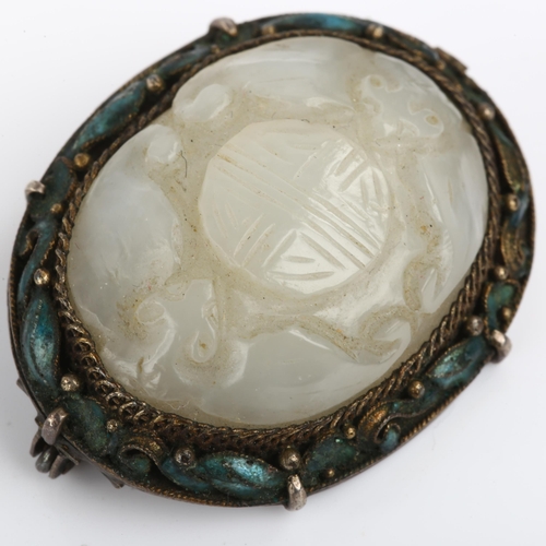 1168 - A Chinese jade and enamel Good Fortune brooch, relief carved with bats and seal, in unmarked white m... 