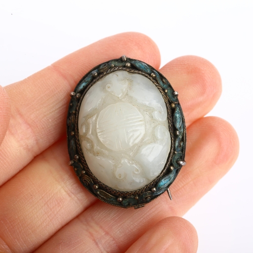 1168 - A Chinese jade and enamel Good Fortune brooch, relief carved with bats and seal, in unmarked white m... 