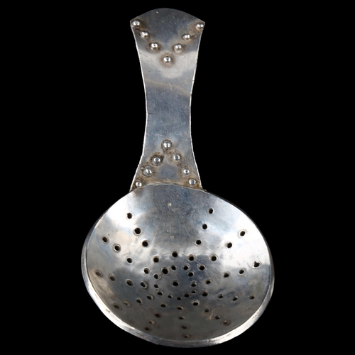 1680 - An Arts and Crafts unmarked silver tea caddy strainer spoon, length 10cm