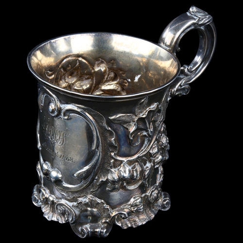 1681 - A Victorian silver half pint christening mug, relief embossed floral decoration with foliate handle,... 