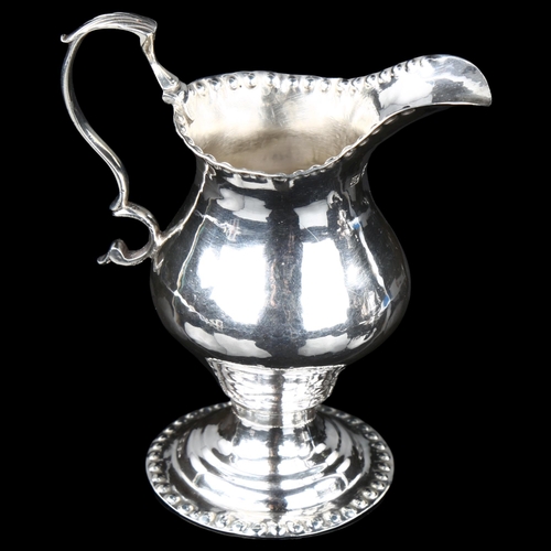 1698 - A George III silver helmet cream jug, by Joseph Lock, hallmarks London 1776, height 10cm, 2.6oz