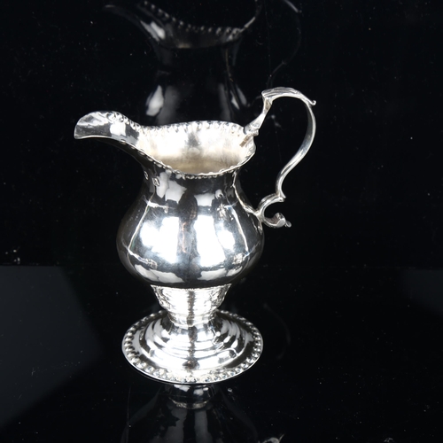 1698 - A George III silver helmet cream jug, by Joseph Lock, hallmarks London 1776, height 10cm, 2.6oz