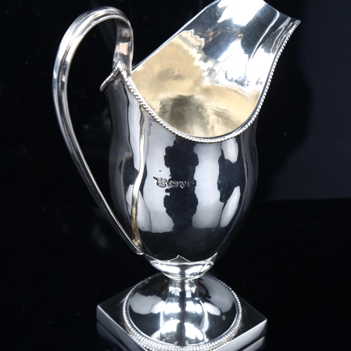 1699 - An Edwardian silver helmet cream jug, with bead edge rim and pedestal base, by George Nathan & Ridle... 