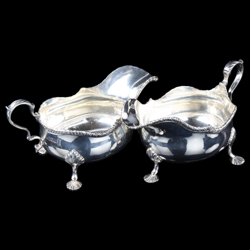 1703 - A large pair of Edwardian silver sauce boats, bulbous form with gadrooned rim, shell feet and acanth... 