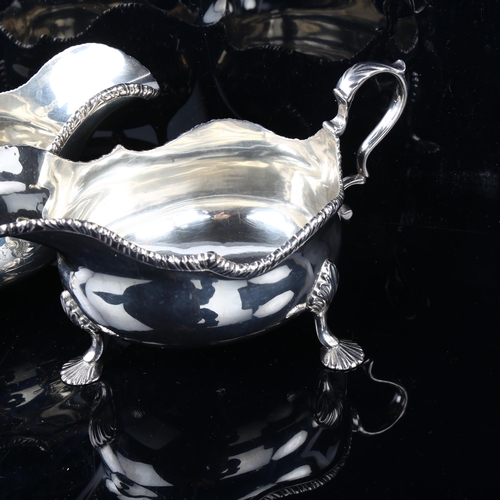 1703 - A large pair of Edwardian silver sauce boats, bulbous form with gadrooned rim, shell feet and acanth... 