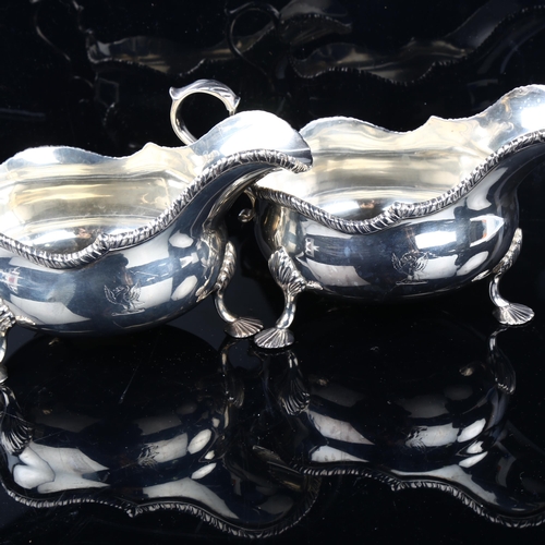 1703 - A large pair of Edwardian silver sauce boats, bulbous form with gadrooned rim, shell feet and acanth... 