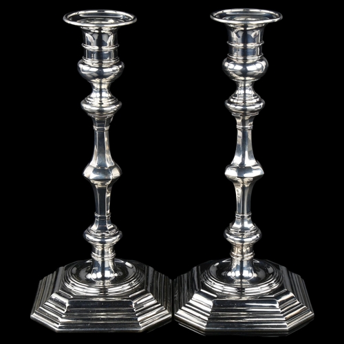 1705 - A heavy matched pair of Edwardian silver table candlesticks, in 18th century style, by Carrington Co... 