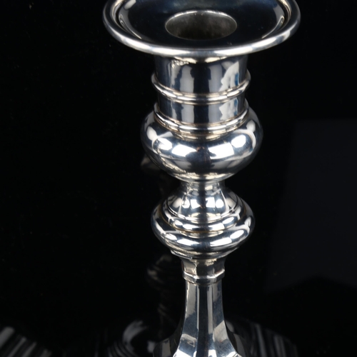 1705 - A heavy matched pair of Edwardian silver table candlesticks, in 18th century style, by Carrington Co... 