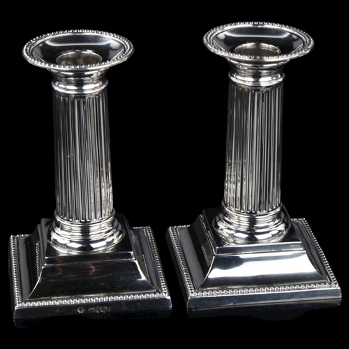 1706 - A pair of Edwardian silver column table candlesticks, with beaded edge and removeable sconces, by Wi... 