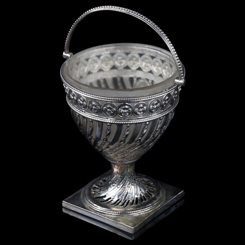 1711 - A 19th century swing-handled sugar basket, unmarked silver with pierced floral decoration, height ex... 