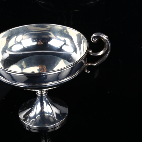 1714 - A pair of Edwardian silver pedestal trophy dishes, circular form with scrolled handles, by S W Smith... 