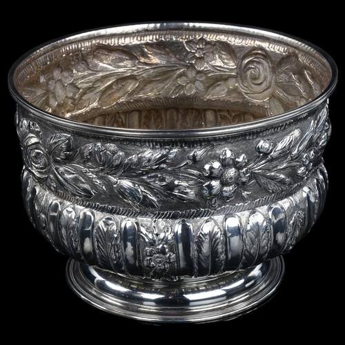 1718 - A large early 20th century unmarked silver rose bowl, circular bulbous form with relief embossed flo... 