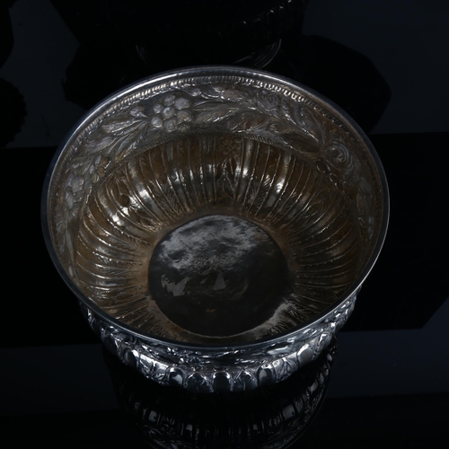 1718 - A large early 20th century unmarked silver rose bowl, circular bulbous form with relief embossed flo... 