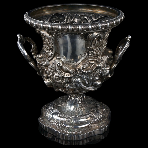 1719 - A fine quality Victorian silver pedestal wine cooler, circular form with high relief embossed foliat... 