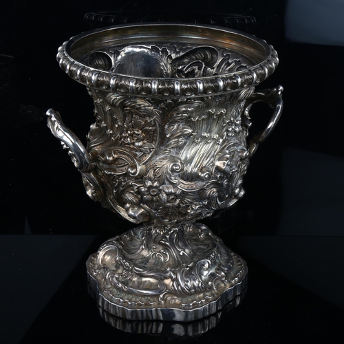 1719 - A fine quality Victorian silver pedestal wine cooler, circular form with high relief embossed foliat... 