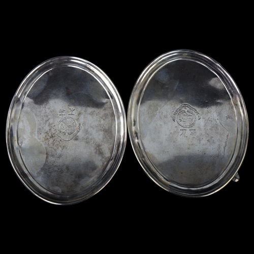 1724 - A pair of Irish George III silver oval teapot stands, with engraved armorial crests, by Robert Bread... 