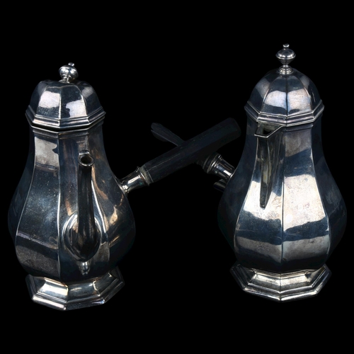 1725 - A pair of Edwardian silver cafe au lait pots, octagonal baluster form with ebony side pouring handle... 