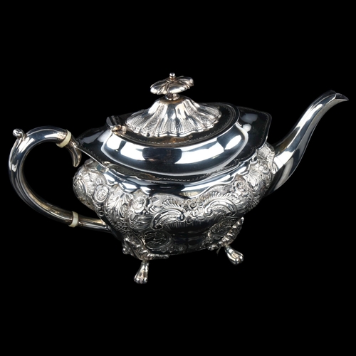 1734 - A late Victorian silver teapot, shaped oval form with relief embossed foliate decoration and ivory i... 