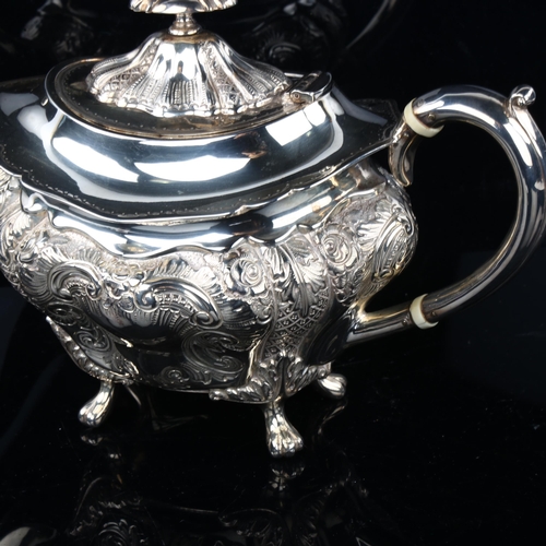 1734 - A late Victorian silver teapot, shaped oval form with relief embossed foliate decoration and ivory i... 