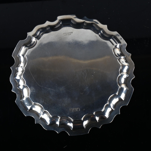 1740 - An Edwardian silver salver, circular form with scalloped rim and swan crest 