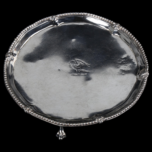 1742 - A George III silver salver, circular form with bead edge, raised on claw and ball feet, by Robert Jo... 