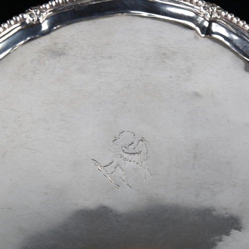 1742 - A George III silver salver, circular form with bead edge, raised on claw and ball feet, by Robert Jo... 