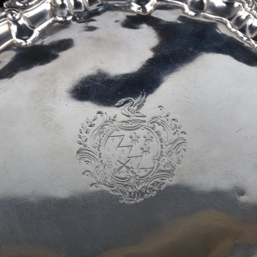 1743 - An Irish George III silver salver, circular form with cast foliate rim, raised on 3 feet, by George ... 