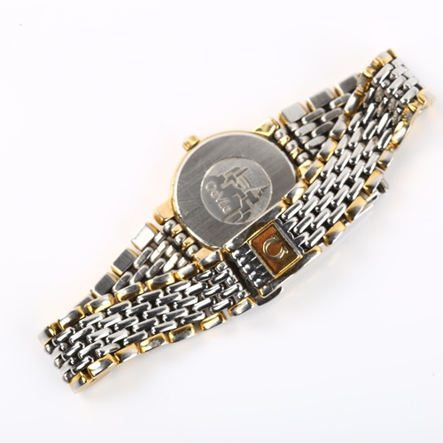 1087 - OMEGA - a lady's gold plated stainless steel De Ville quartz bracelet watch, champagne dial with gil... 